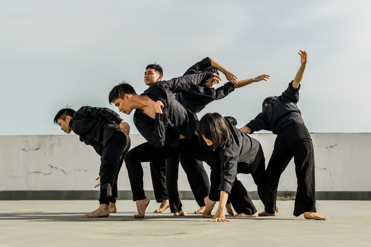 portfolio-05 A group of adults performing dynamic contemporary dance on a rooftop.